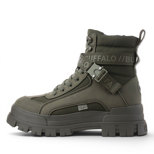 Buffalo olive green combat boots with buckle strap and lug sole. Textile and synthetic upper.