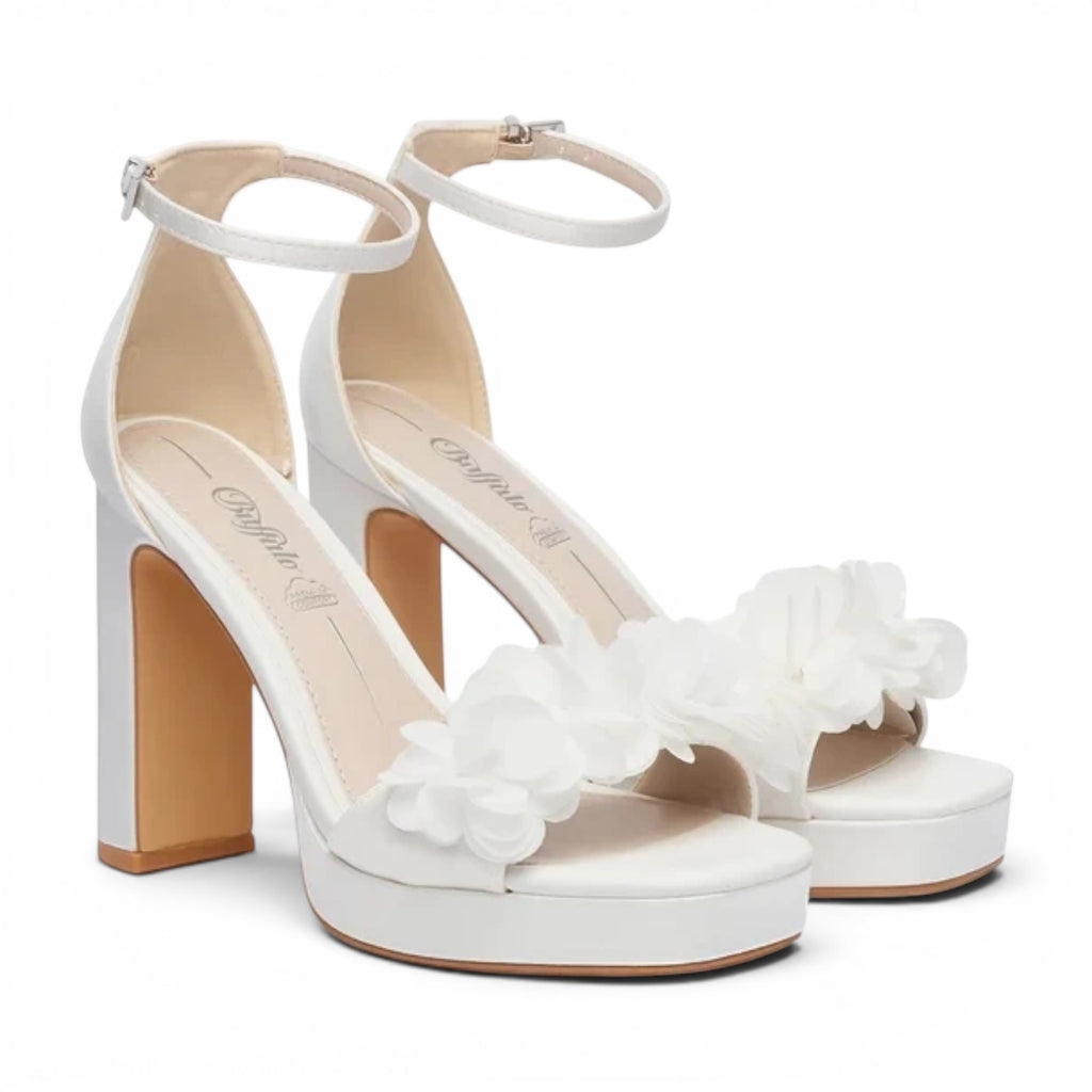 Buffalo white platform block heel sandals with ankle straps and floral embellishments.