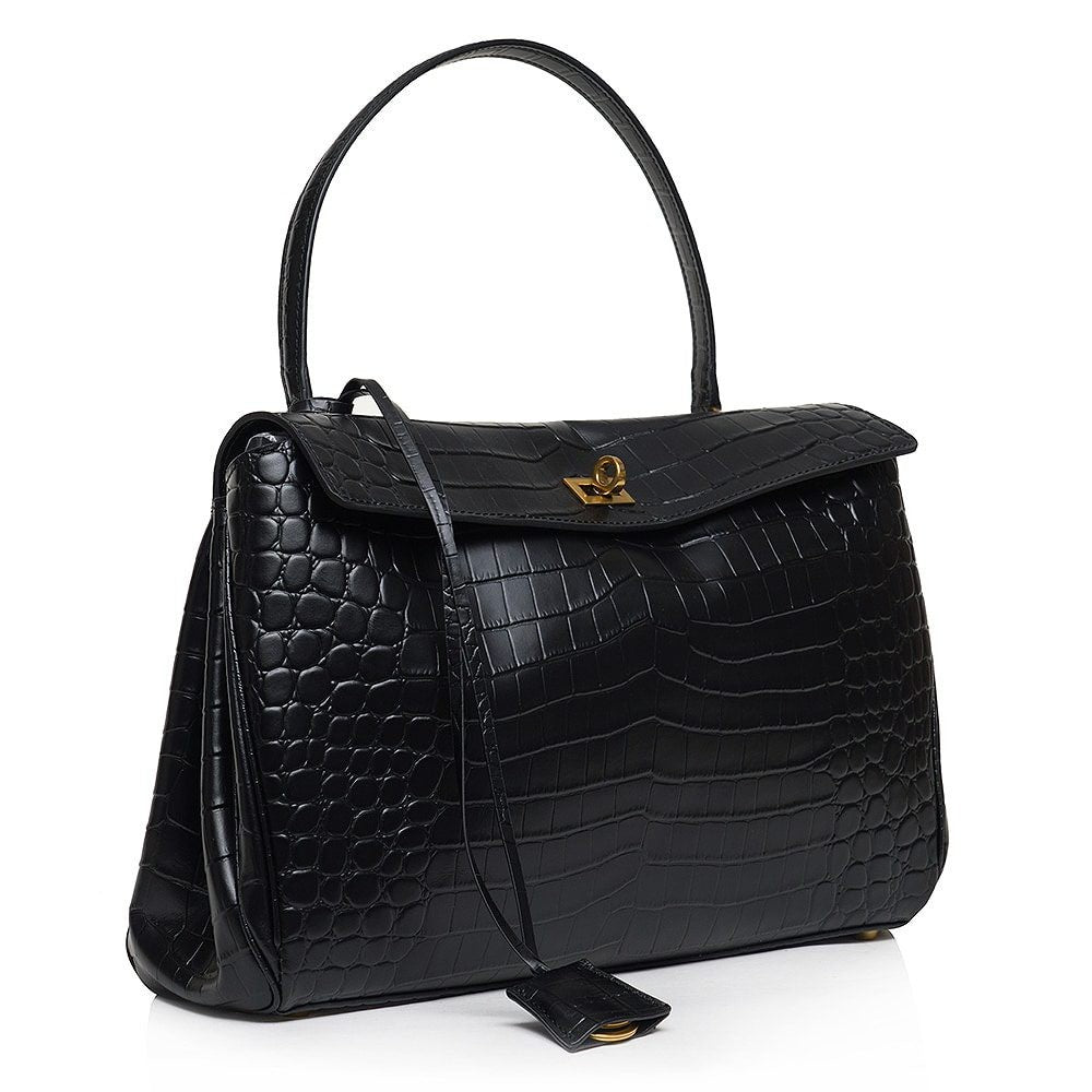 ShoeShop Rodeo black leather handbag with crocodile embossed texture, gold turn-lock closure, and detachable strap.