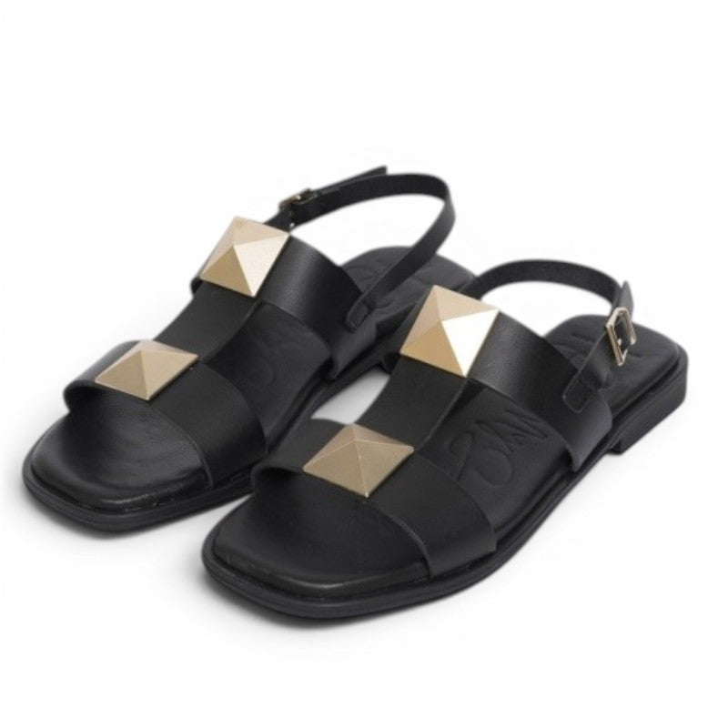 My Store black leather flat sandals with gold pyramid stud embellishments and ankle strap.