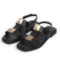 My Store black leather flat sandals with gold pyramid stud embellishments and ankle strap.