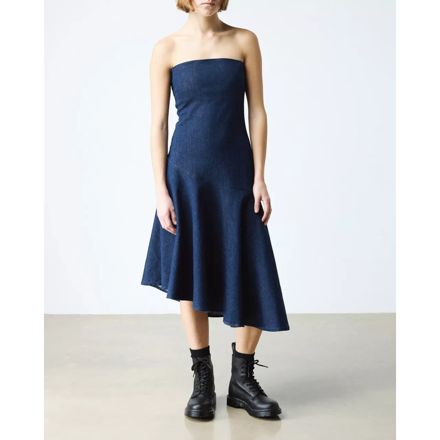 My Store dark blue denim strapless midi dress with a flared skirt, worn by a model with black lace-up boots.