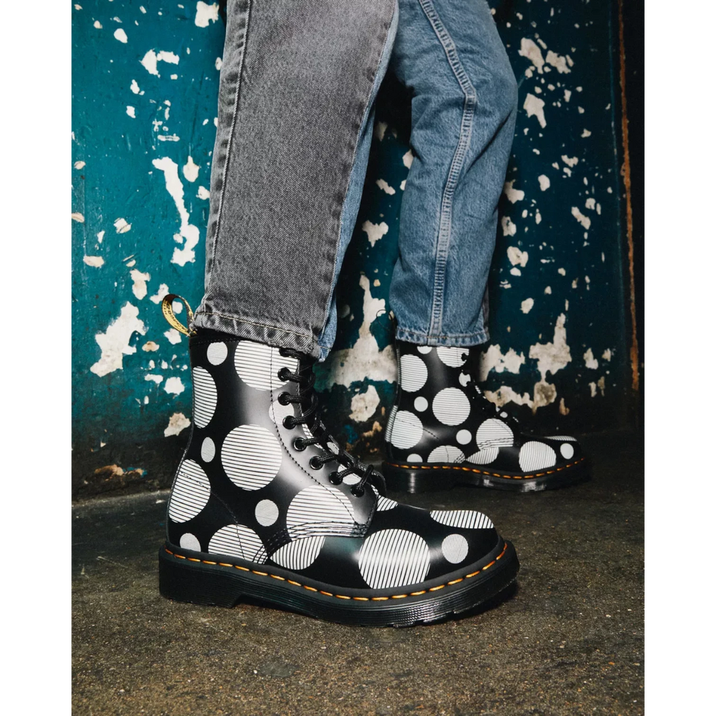 My Store Dr. Martens 1460 black smooth leather boots with white polka dot pattern and yellow stitching.