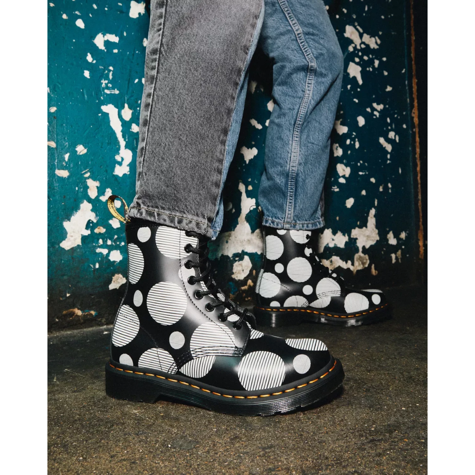 My Store Dr. Martens 1460 black smooth leather boots with white polka dot pattern and yellow stitching.