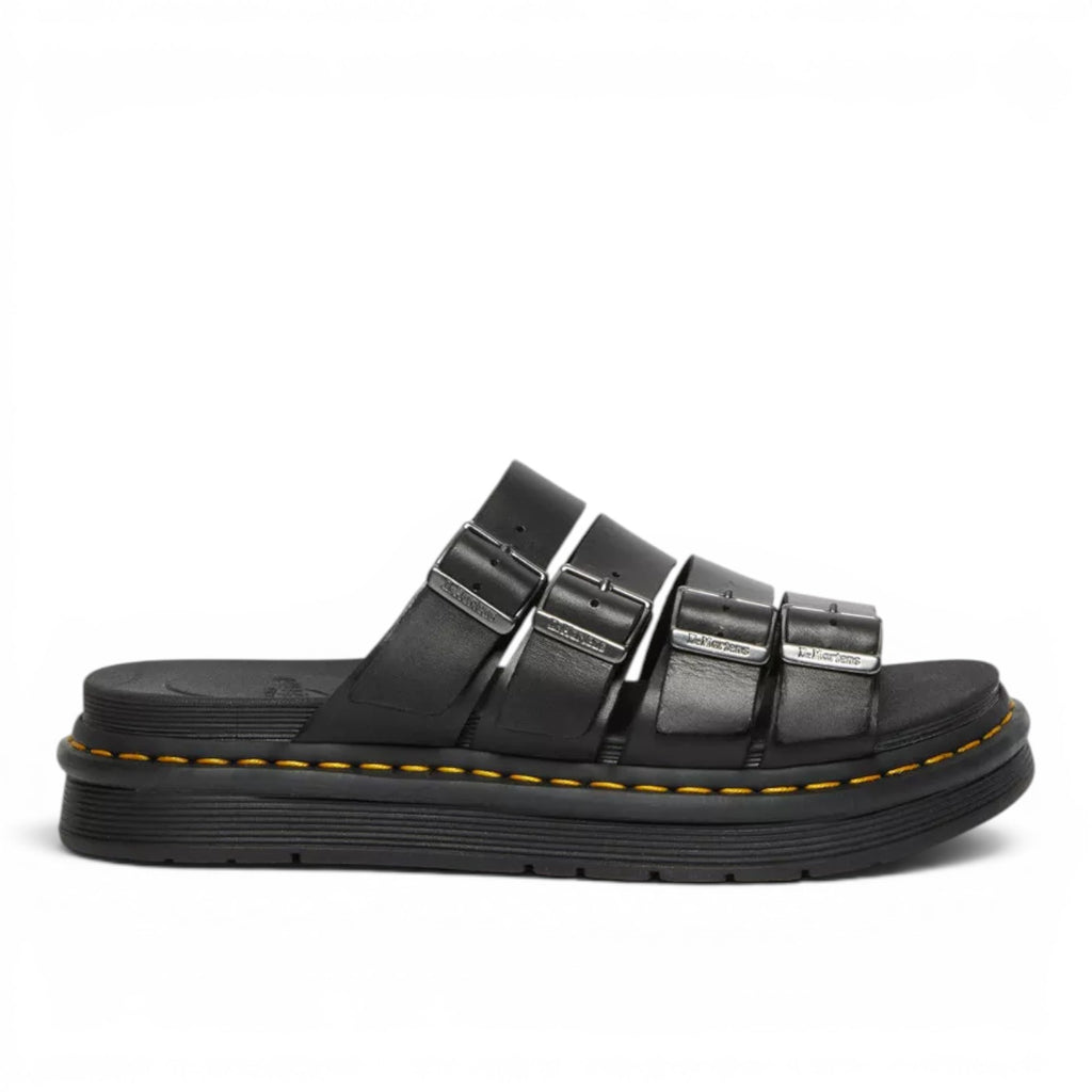 My Store Dr. Martens Tate Brando black leather slide sandals with three adjustable buckle straps and yellow stitching on a thick EVA sole.