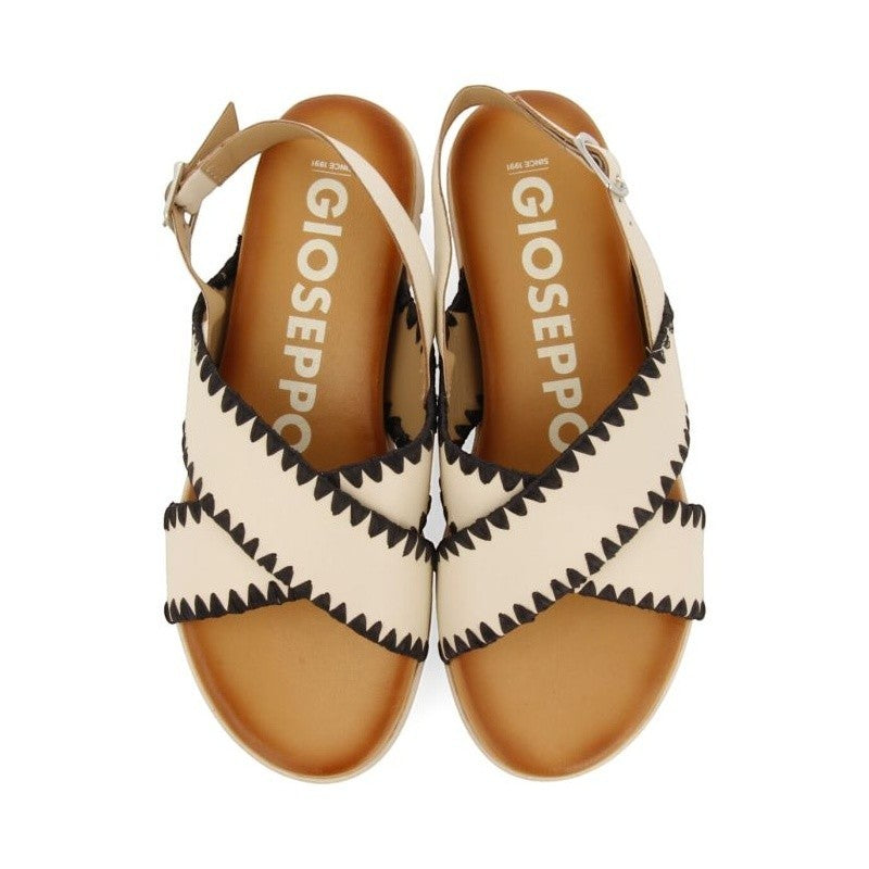 My Store cream leather sandals with black zigzag stitching and criss-cross straps. Features adjustable ankle strap.