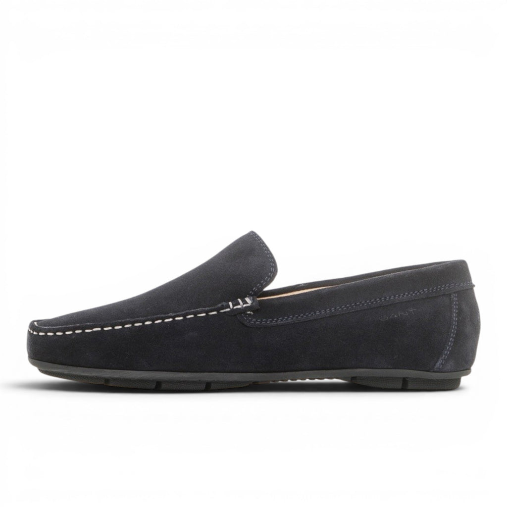 My Store navy blue suede moccasin shoes with white stitching and a rubber sole.