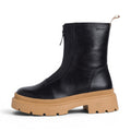 My Store black leather ankle boots with a tan lug sole and front zipper closure.