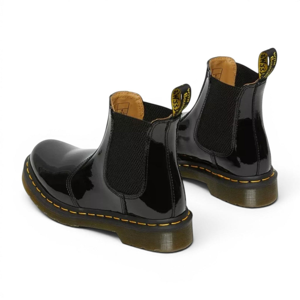 My Store Dr. Martens 2976 black patent leather Chelsea boots with yellow stitching and elastic side panels.