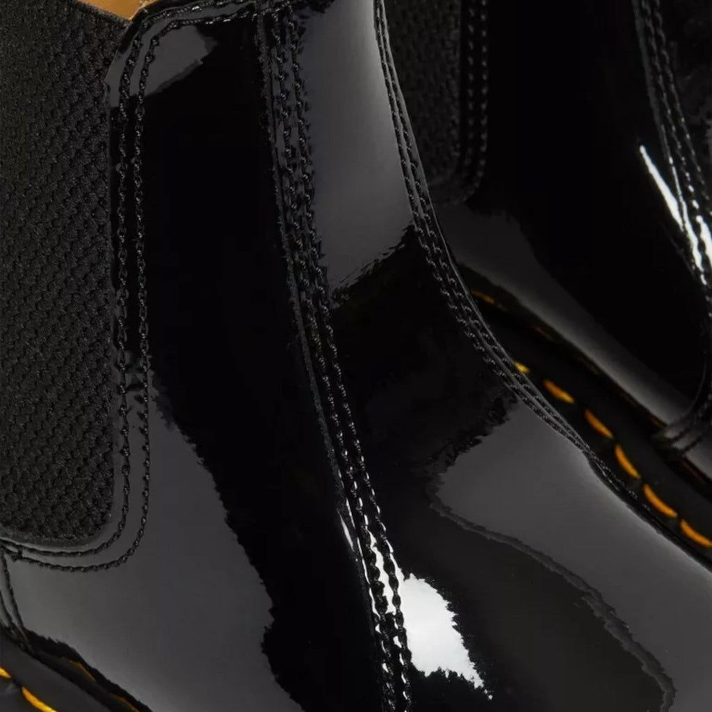 My Store Dr. Martens 2976 black patent leather Chelsea boots with elastic side panels and yellow stitching.