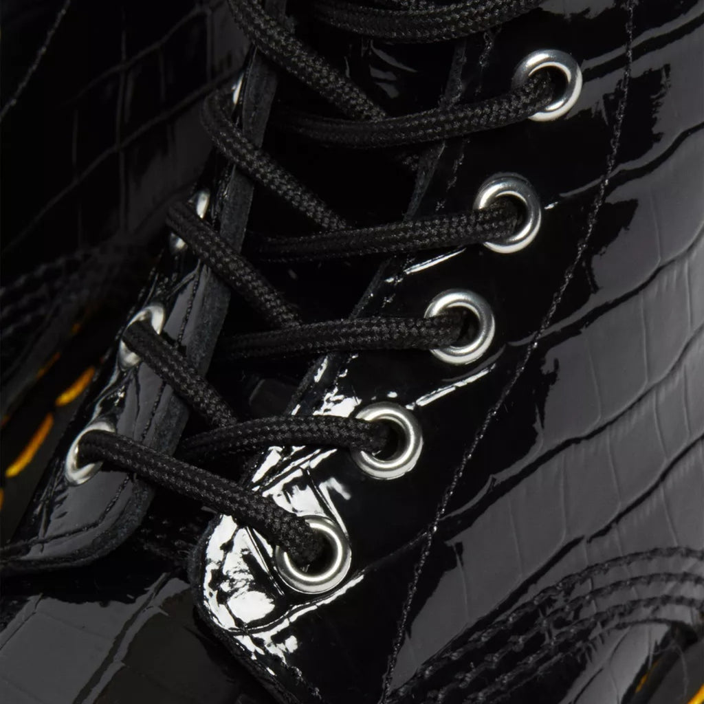 My Store Dr. Martens 1460 Patent Croc Emboss black patent leather lace-up boots with silver eyelets.
