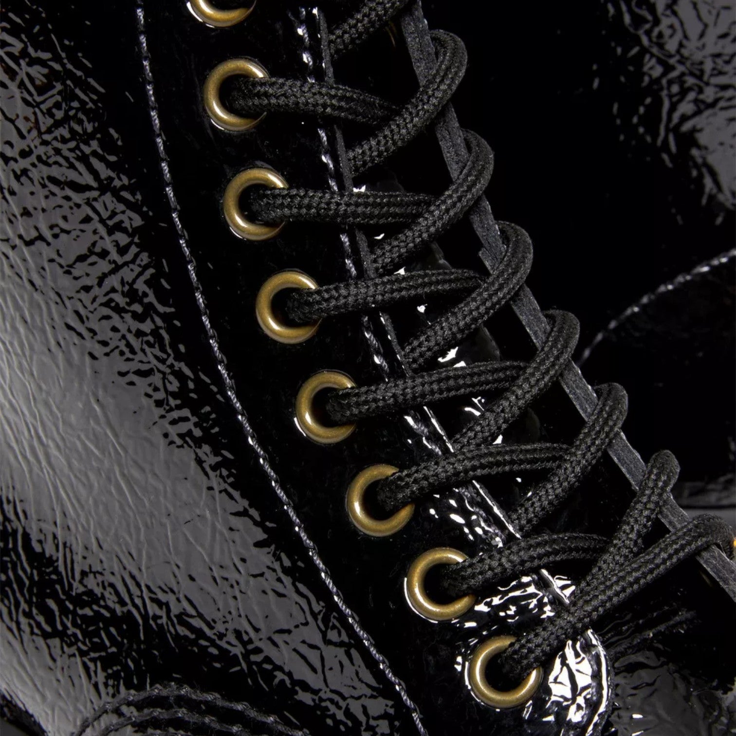 My Store black patent leather Dr. Martens Sinclair boots with black laces and gold eyelets.
