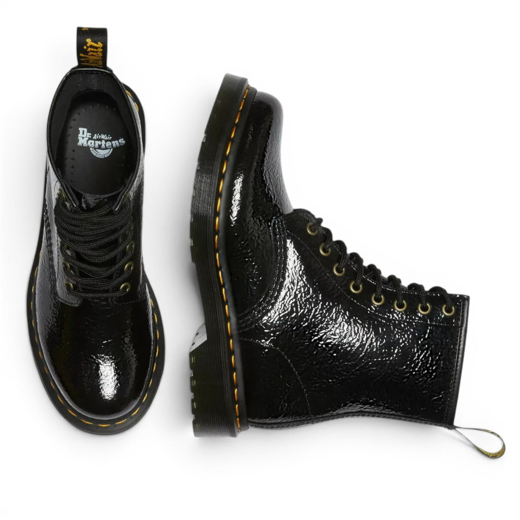 My Store Dr. Martens 1460 black patent leather distressed ankle boots with yellow stitching and lace-up closure.