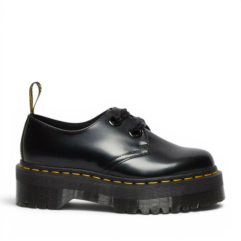 My Store Dr. Martens black leather Holly Platform shoes with satin laces and yellow stitching on a thick platform sole.