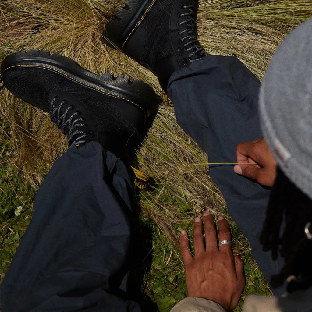 My Store Dr. Martens Tarik Utility black leather and recycled textile boots with yellow stitching and rugged sole.