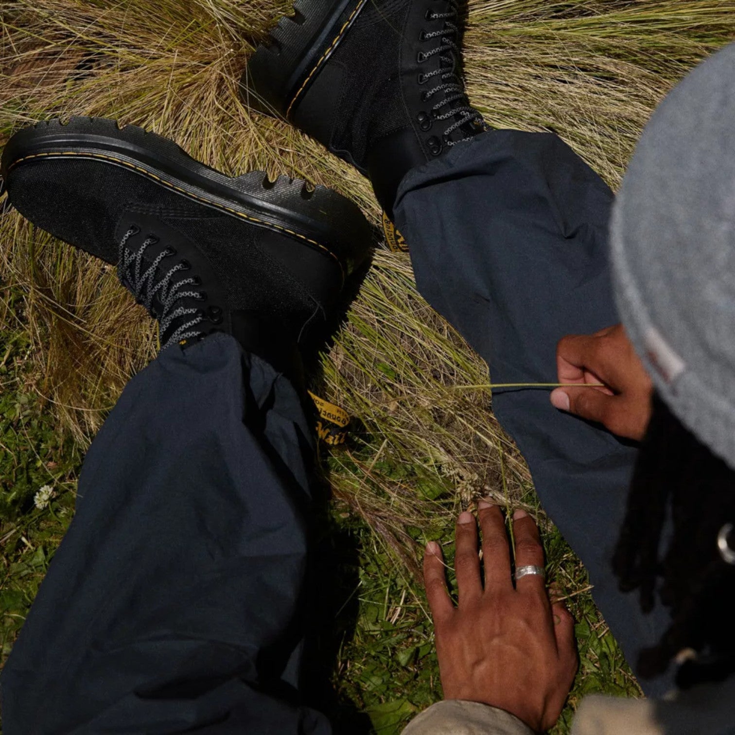 My Store Dr. Martens Tarik Utility black leather and recycled textile boots with yellow stitching and rugged sole.