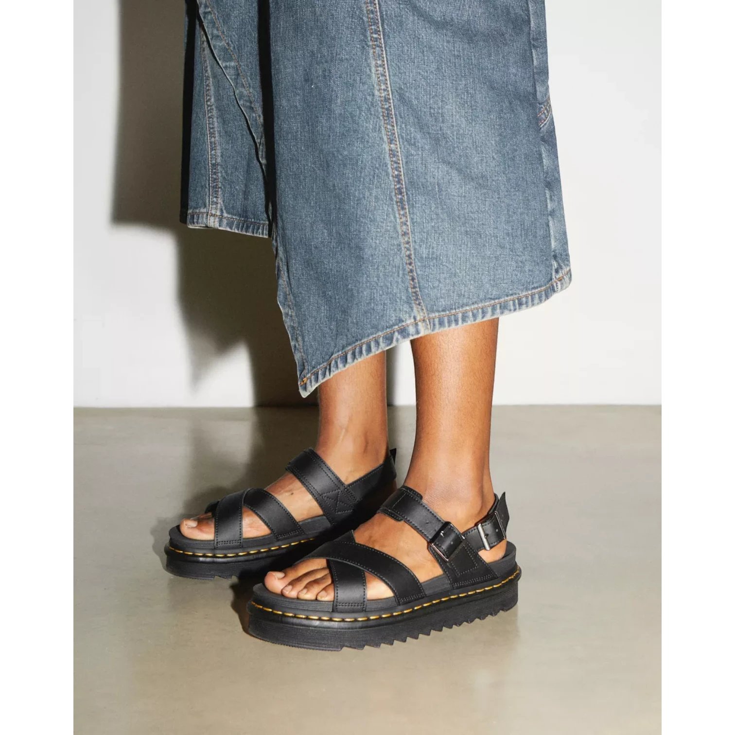 My Store Dr. Martens Voss II Hydro Leather black platform sandals with criss-cross straps and buckle closure.