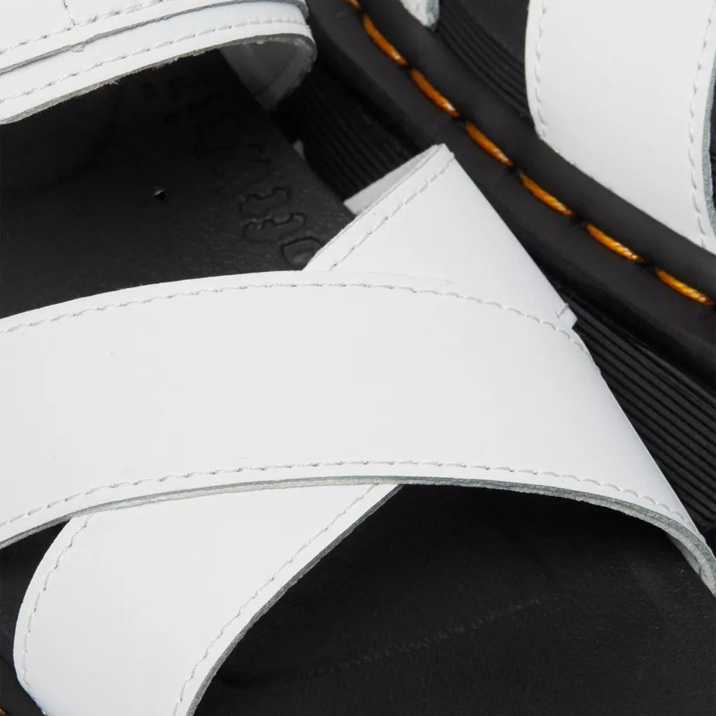 My Store Dr. Martens Voss II Hydro Leather white criss-cross strap sandals with black EVA sole and yellow stitching.