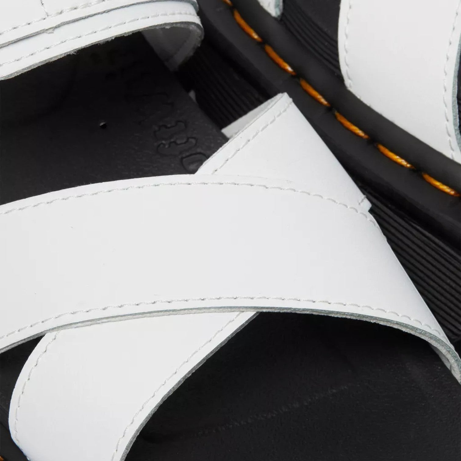 My Store Dr. Martens Voss II Hydro Leather white criss-cross strap sandals with black EVA sole and yellow stitching.