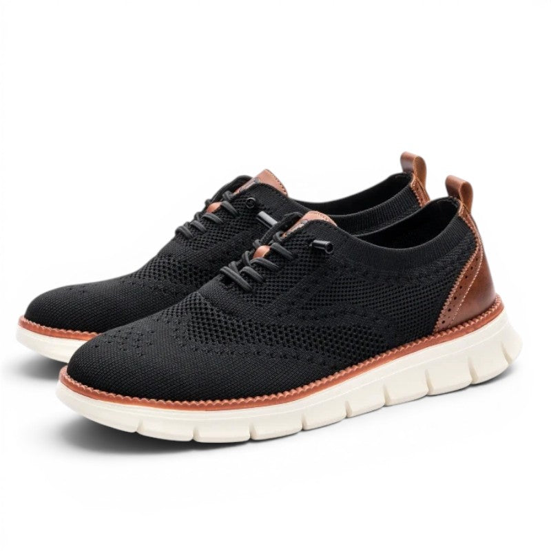 ShoeShop black knit wingtip sneakers with brown leather accents and white soles. Breathable and flexible.