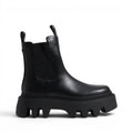 ShoeShop black leather Chelsea boots with elastic side panels and a chunky lug sole.