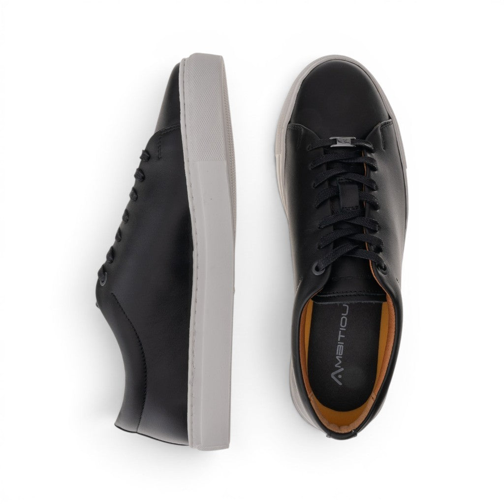 ShoeShop black leather low-top sneakers with white soles and lace-up closure.
