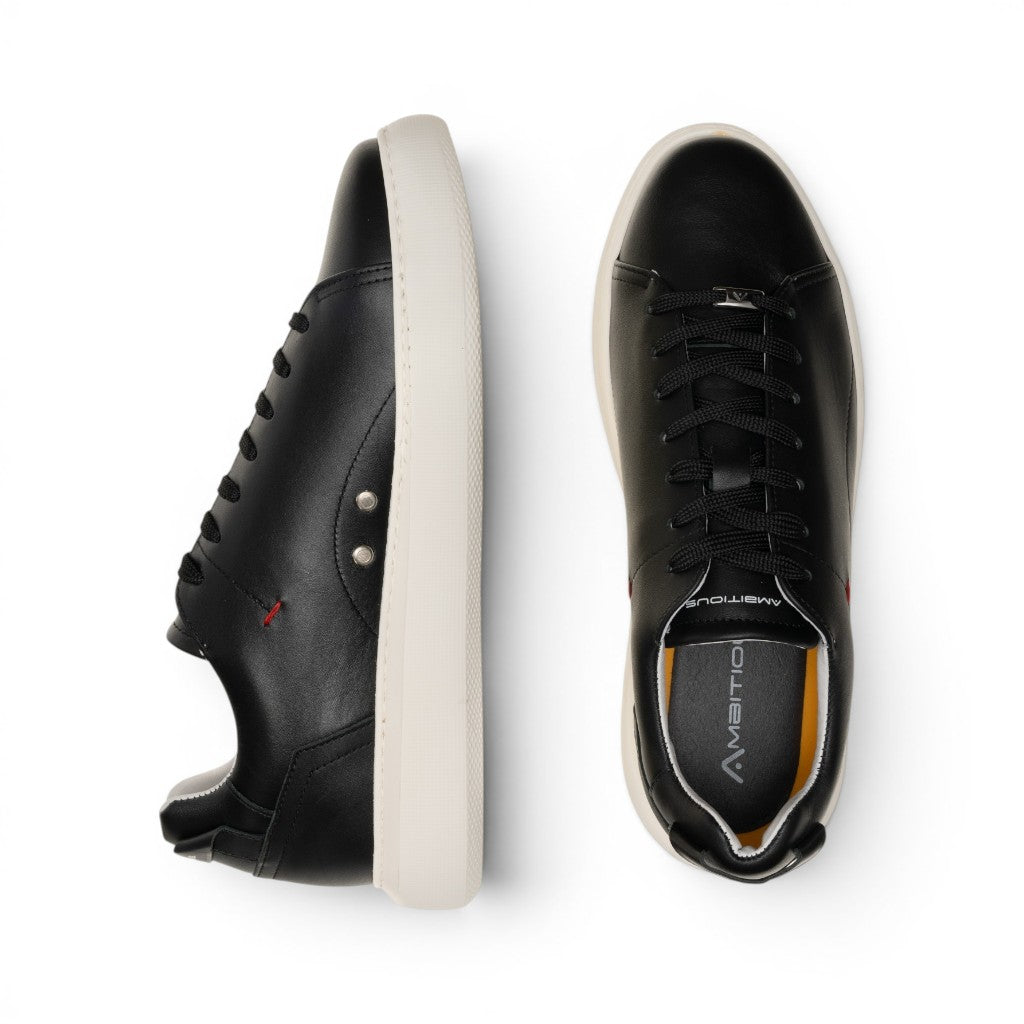 ShoeShop black leather low-top sneakers with white soles and red accent stitching.
