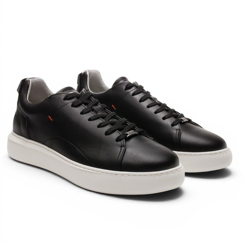 ShoeShop black leather low-top sneakers with white platform sole and orange accent detail.