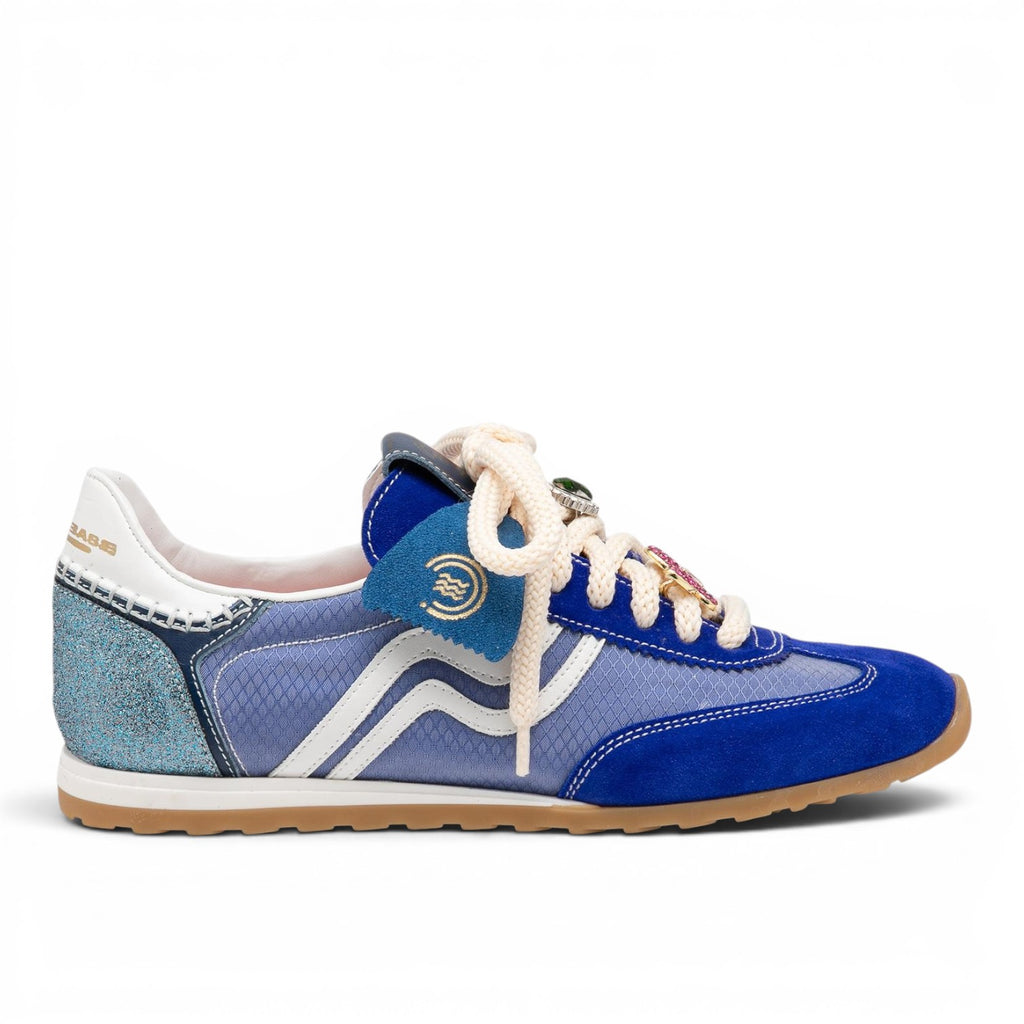 ShoeShop blue suede and mesh low-top sneakers with white stripes and jewel-like lace details.