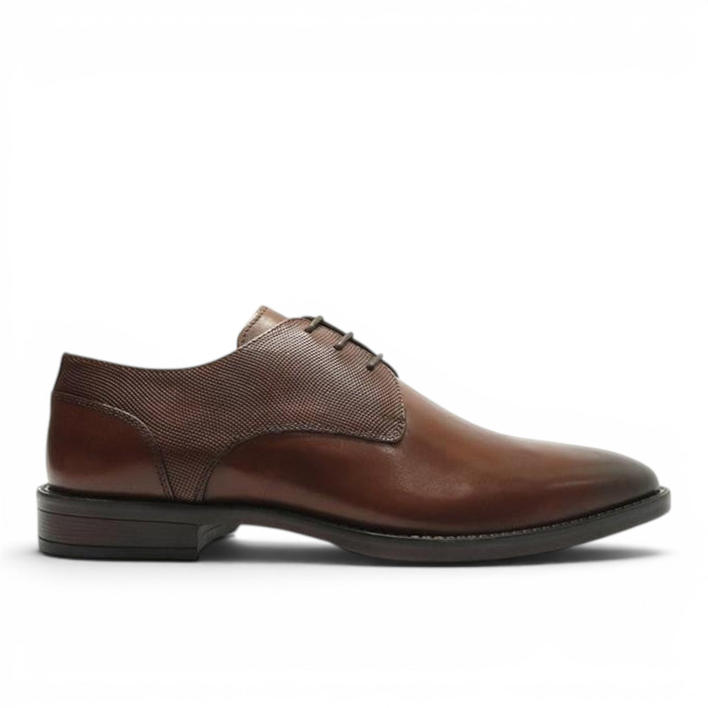 ShoeShop brown leather dress shoe with textured fabric accents and lace-up closure.