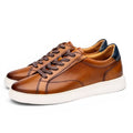 ShoeShop brown leather men's casual sneakers with perforated details and navy heel accent.