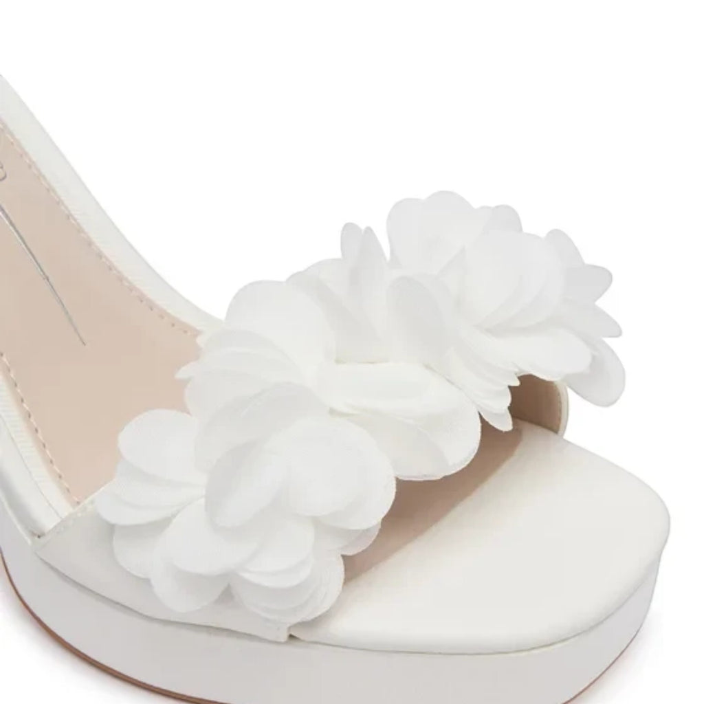 ShoeShop white platform sandals with fabric floral embellishments on the toe strap.