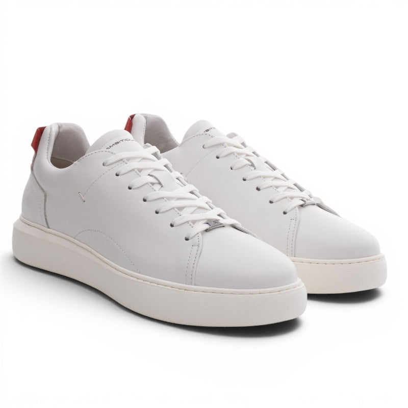 ShoeShop white leather low-top sneakers with red heel tab and white laces. Model 10443A.