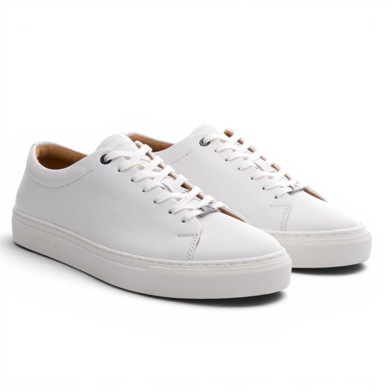 ShoeShop white leather low-top sneakers with white laces and a thick rubber sole. Model 11187A.