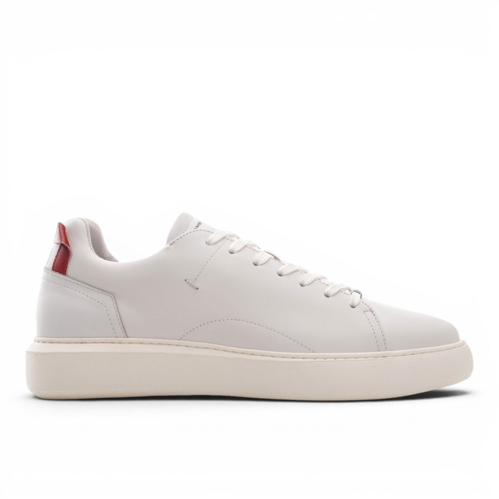 ShoeShop white leather low-top sneakers with a red heel accent and cream sole.