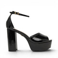 ShoeShop Jessie Neat black patent platform sandals with ankle strap and chunky heel.
