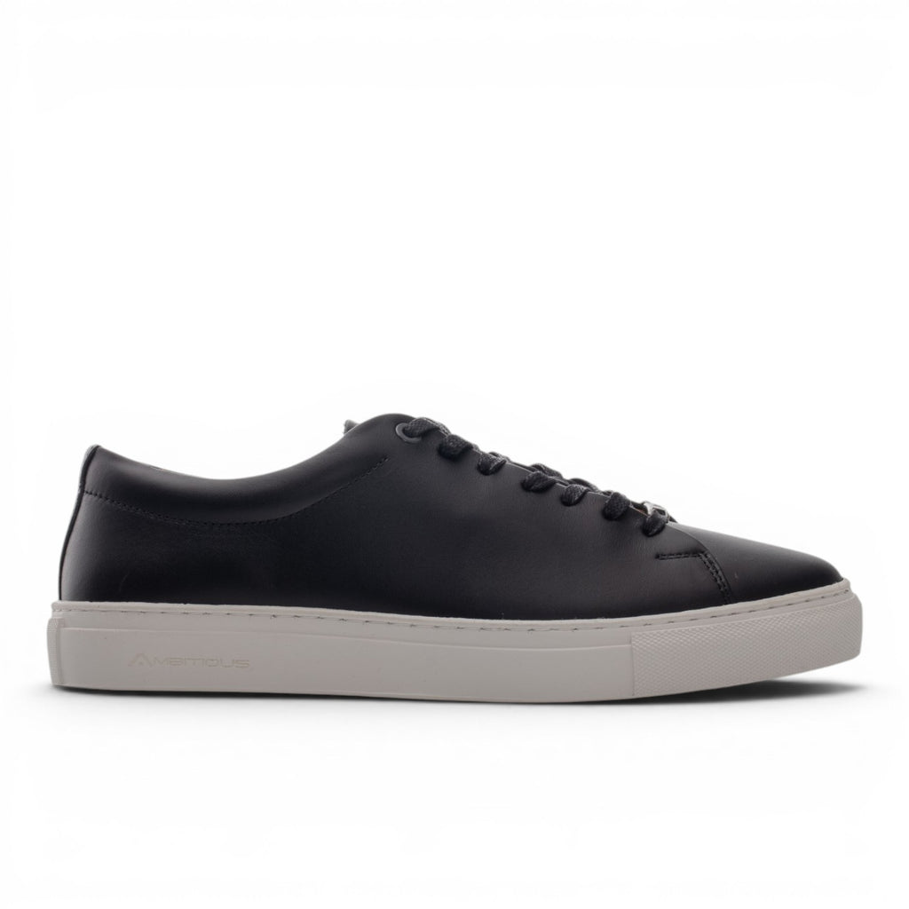 ShoeShopHere black leather low-top sneakers with a light grey sole and lace-up closure.