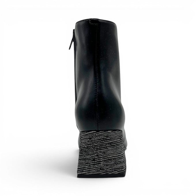 ShoeShop The Other Woman black ankle boot with a textured silver and black block heel, rear view