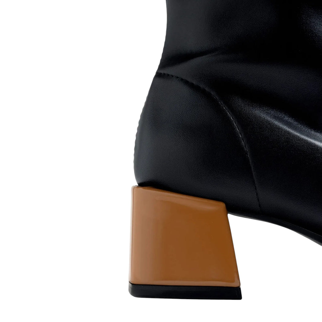 ShoeShop black leather boot with a distinctive chunky tan block heel