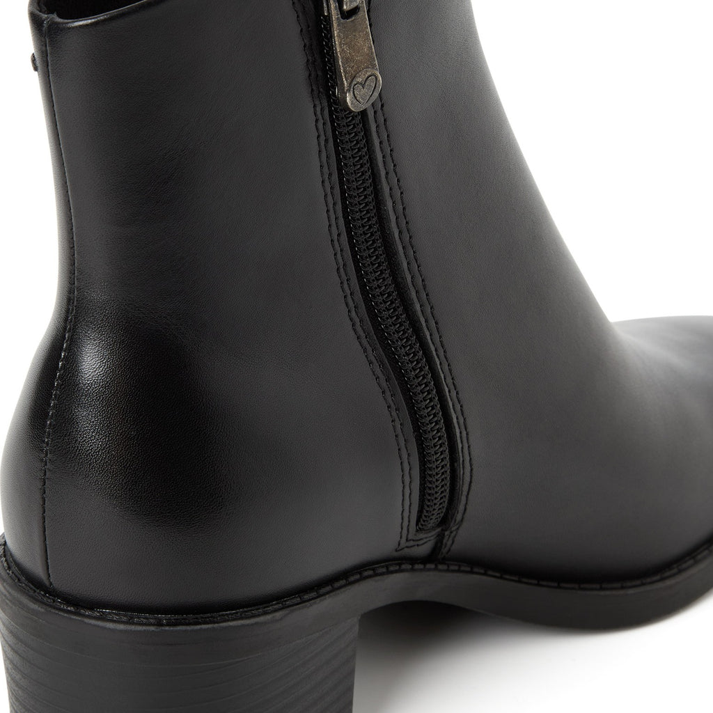 ShoeShop black leather ankle boot with a side zipper featuring a heart-shaped pull tab detail