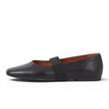 ShoeShop black leather ballet flats with elastic strap and round toe. Low 11mm heel.