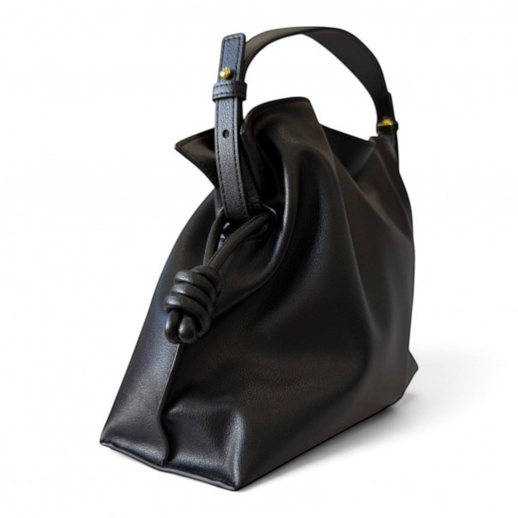 ShoeShop black leather handbag with a soft structure, drawstring closure, and detachable shoulder strap.
