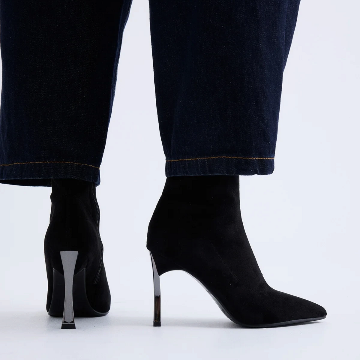 ShoeShop black synthetic ankle boots with a 9.5cm stiletto heel, worn with dark denim jeans.