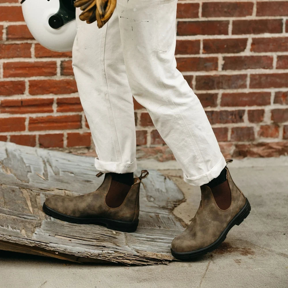 ShoeShop Blundstone 585 rustic brown leather Chelsea boots worn with white trousers on a city sidewalk