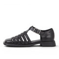 ShoeShop Brittie black leather fisherman sandals with buckle strap and woven detail.