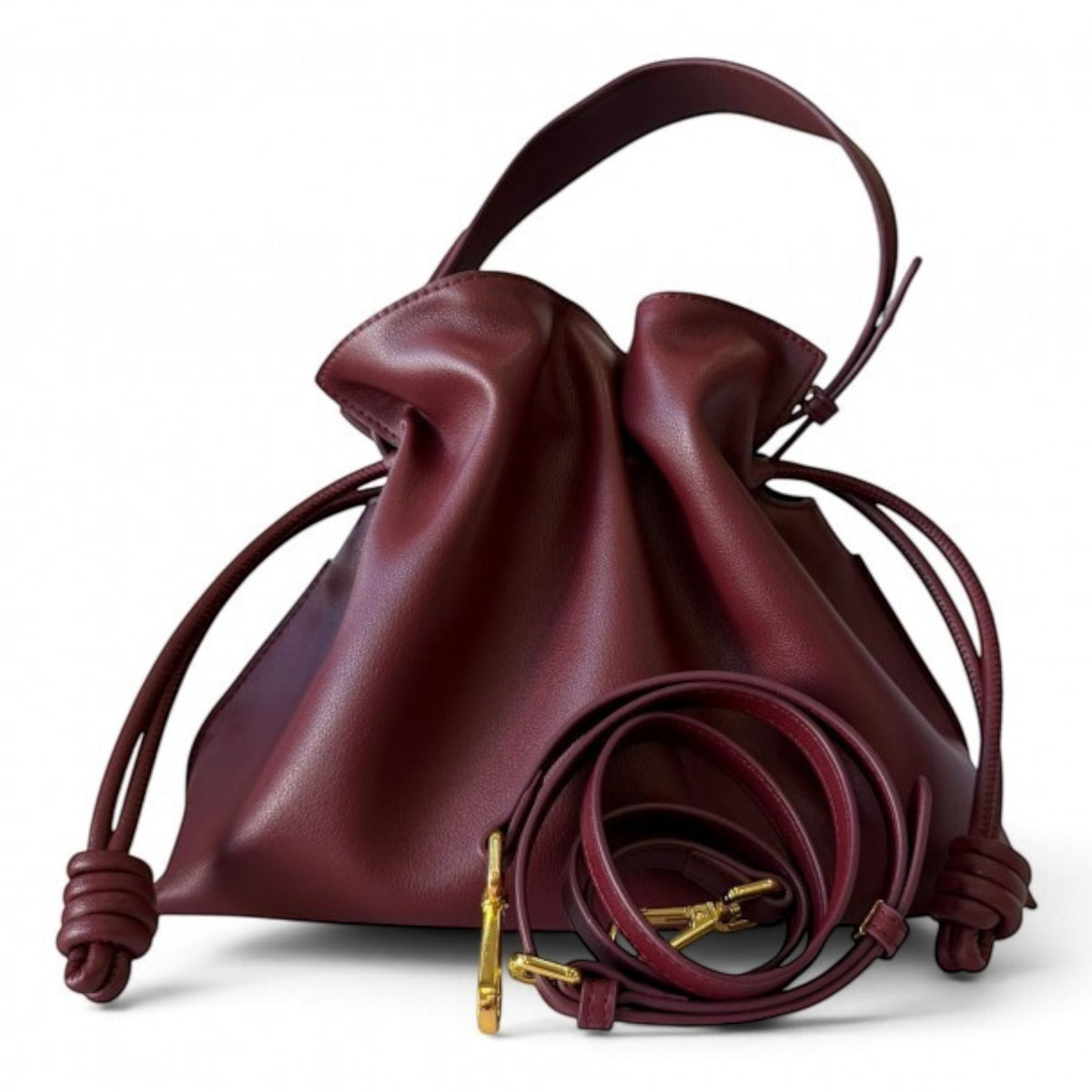 ShoeShop burgundy leather drawstring handbag with a soft slouchy design and detachable shoulder strap