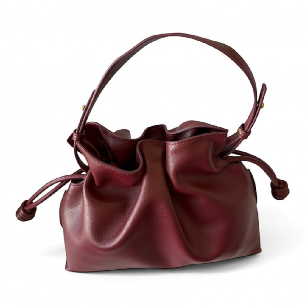 ShoeShop burgundy leather drawstring handbag with a soft, slouchy design and removable shoulder strap.