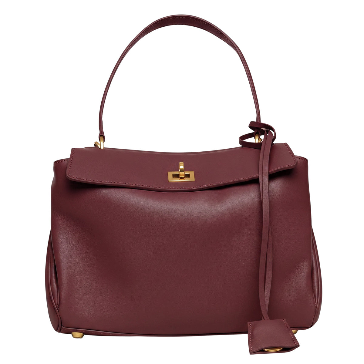 ShoeShop burgundy leather handbag with a top handle, gold-tone turn-lock closure, and a decorative leather tag.