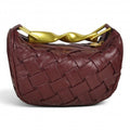 ShoeShop burgundy woven leather handbag with a unique gold-toned twisted metal handle
