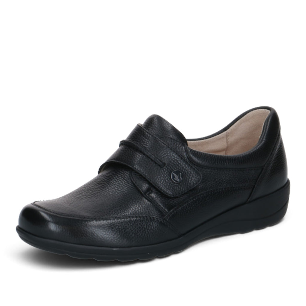 ShoeShop Caprice black leather comfort shoe with a wide H fit, hook-and-loop strap, and durable rubber sole.